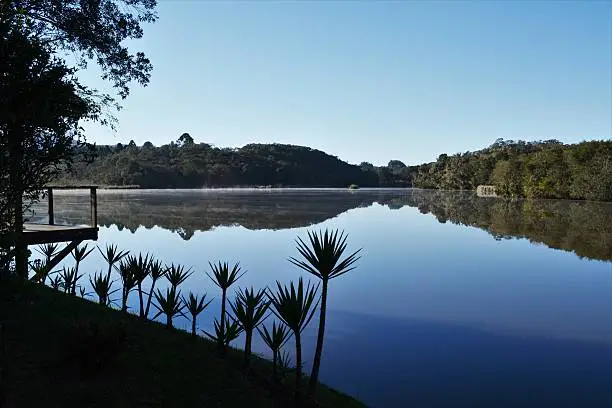 Beautiful rural landscape with trees, lakes, blue sky, lawn and lots of tranquility and peace, photographed in South Tijucas, Paraná on September 16, 2016.