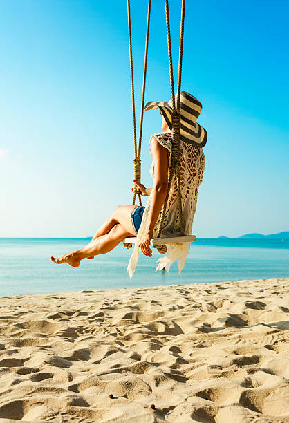 istock Woman at tropical swing 611308592