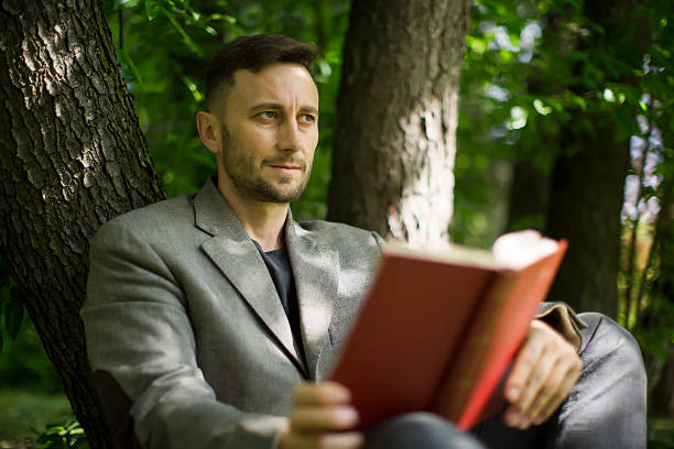istock man reading book about modern psychology 611308948