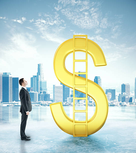 istock Businessman looking at dollar sign 611309558