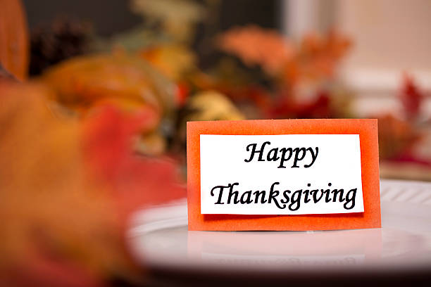istock Happy Thanksgiving place setting with autumn centerpiece on table. 611310014