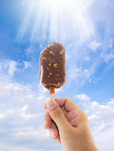 istock Ice Cream holded by hand on  sky background 611310826