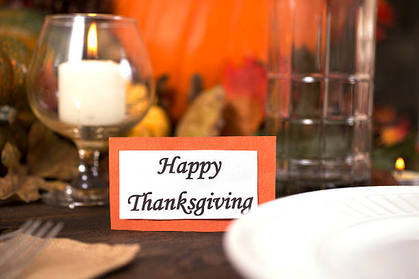 istock Happy Thanksgiving place setting with autumn centerpiece on table. 611311122