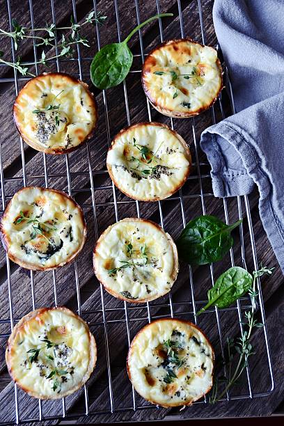 istock Cheese and spinach tarts, top view 611312124