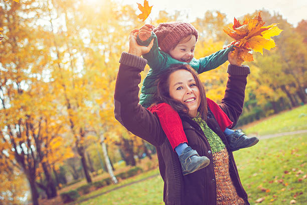 istock Mother with her daughter in autumn park 611312664