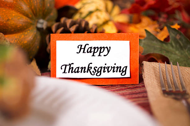 istock Happy Thanksgiving place setting with autumn centerpiece on table. 611313040