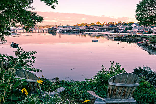 Maine harbor scene at dawn from a romantic garden with chairs