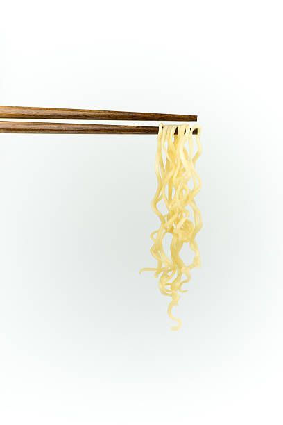 istock chopsticks noodles isolated on white background 611313804