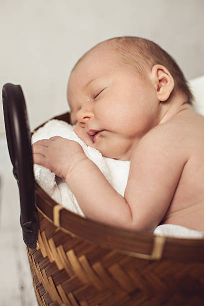 istock Sleeping Newborn Baby In A Basket 611314792