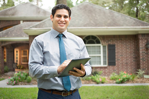 istock Real estate agent with digital tablet and home. 611314856