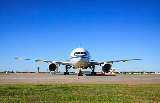 A white Boeing 767 cargo lands at Portland International Airport.