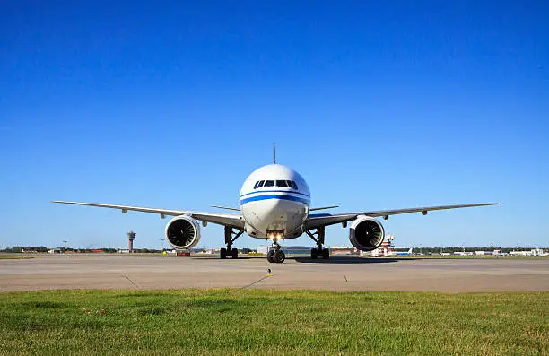 Big passenger airplane boeing 777 on its way to terminal
