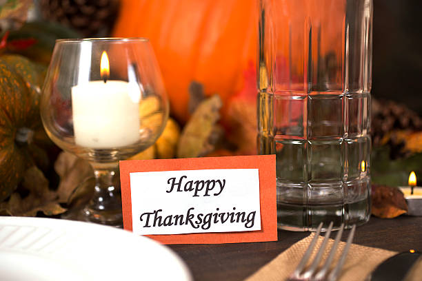 istock Happy Thanksgiving place setting with autumn centerpiece on table. 611315548