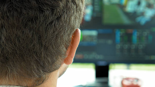 istock Video broadcast editor with headphones at screen 611315716