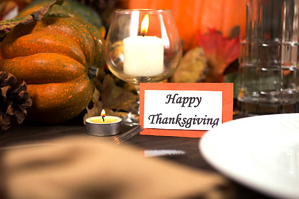 istock Happy Thanksgiving place setting with autumn centerpiece on table. 611316148