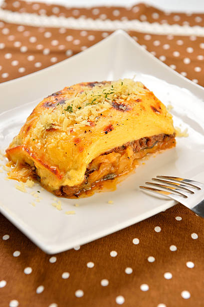 istock Special potato cake with meat on white plate 611316248