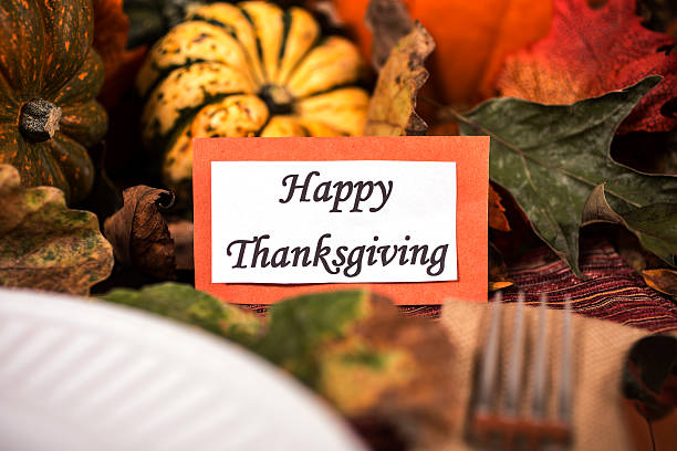 istock Happy Thanksgiving place setting with autumn centerpiece on table. 611317012
