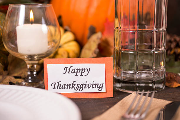 istock Happy Thanksgiving place setting with autumn centerpiece on table. 611317288