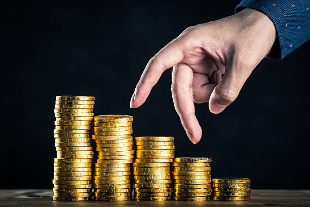 istock hands of man who pile up the gold 611318190