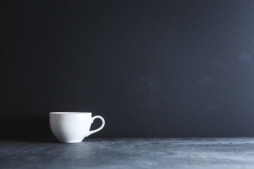 Coffee on black table with black background.