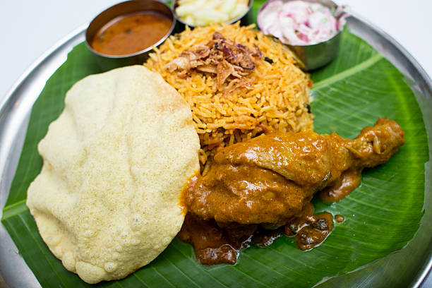 istock Indian meal with curry chiken and plain rice on banana 611318912