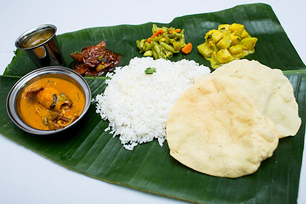 istock Indian meal with curry squid and plain rice on banana 611318976