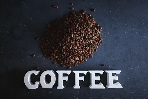 Single word 'COFFEE' and medium roasted coffee beans.