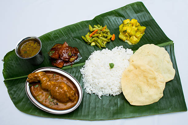 istock Indian meal with braised chiken and plain rice on banana 611319094