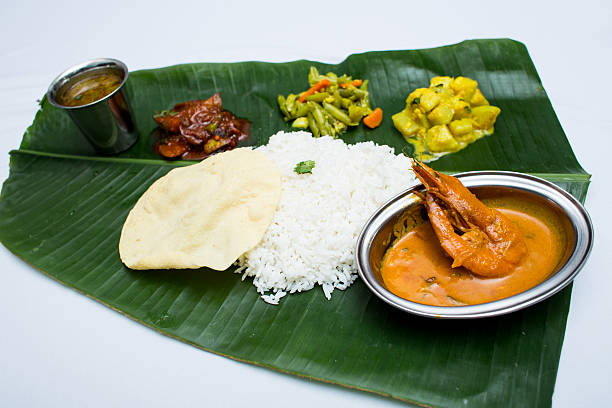 istock Indian meal with curry shrimp and plain rice on banana 611319148