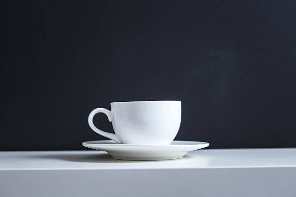 istock White coffee cup on black background 611319162