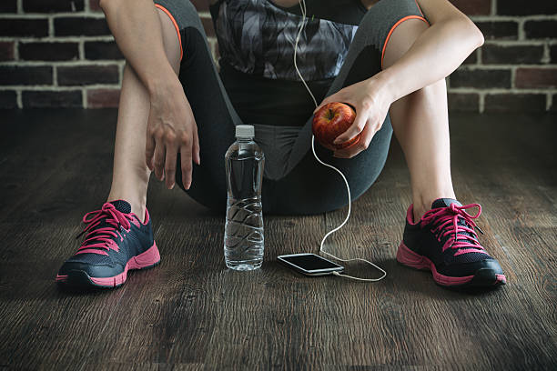 istock take rest listening to music drinking water eating apple 611319784