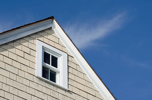 istock House peak with window and blue sky 611320994