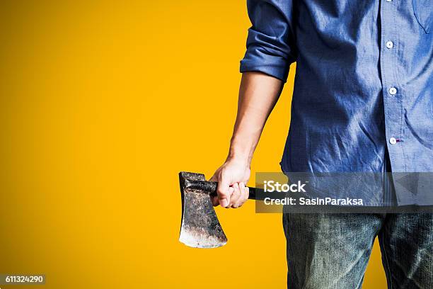 Man Holding Old Rusty Axe On Yellow Background Stock Photo - Download Image Now - Axe, Serial Killings, Adult