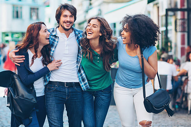 istock Smiling young man with three beautiful girls 611324512
