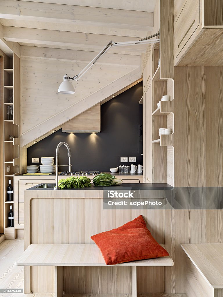 wooden modern kitchen foreground oh a wooden modern kitchen island in the attic room Attic Stock Photo