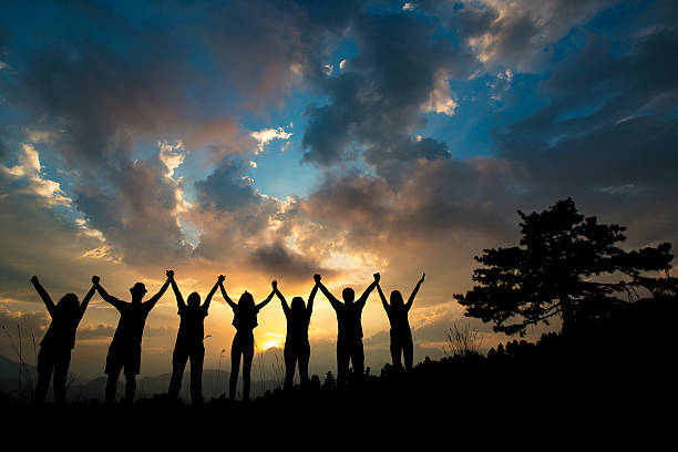 istock silhouettes of people on mountains 611325502