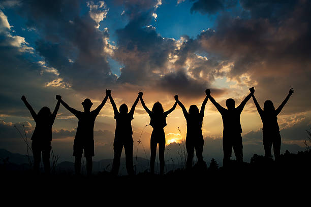 istock silhouettes of people on mountains 611325520