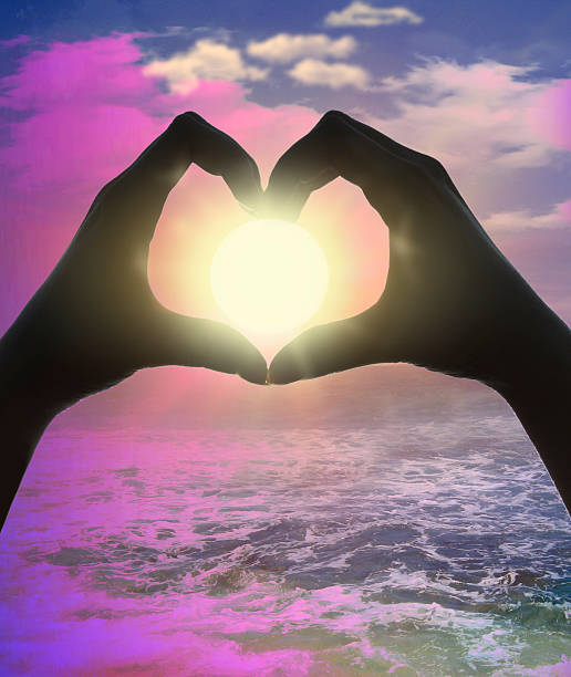 istock Heart shape with hands against the sun at dust 611326018