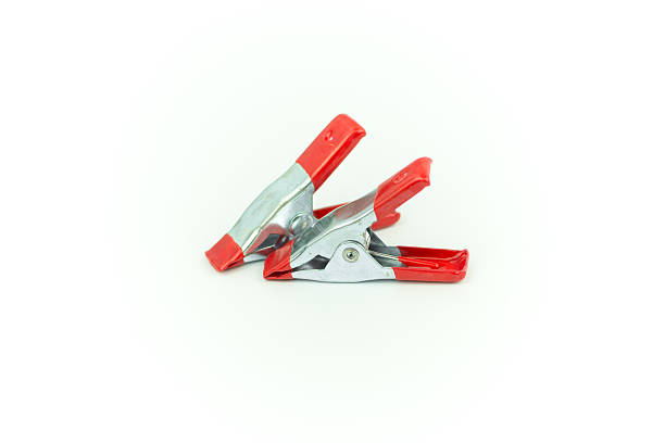 istock Metal spring clamp with red plastic isolated on white 611329572