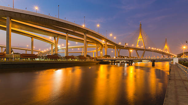 istock Night view over Suspension bridge connect to highway interchanged 611330922
