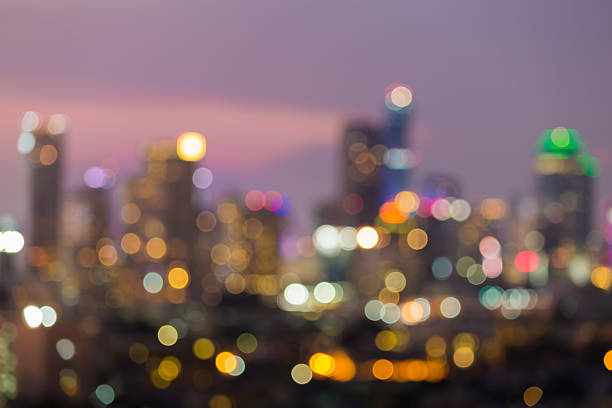 istock Blurred bokeh lights multiple colour office building in city downtown 611331682