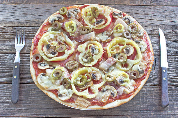 istock Fresh pizza served on wooden table 611333968