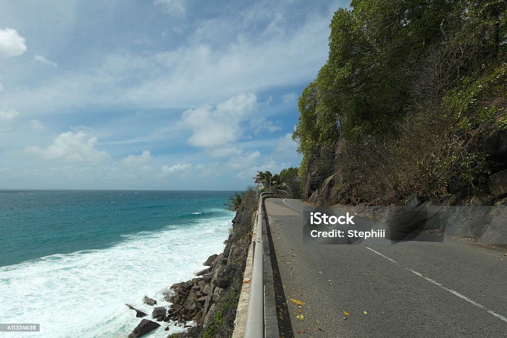 Empty coastal road on Mahe Island - Seychelles Bay of Water Stock Photo