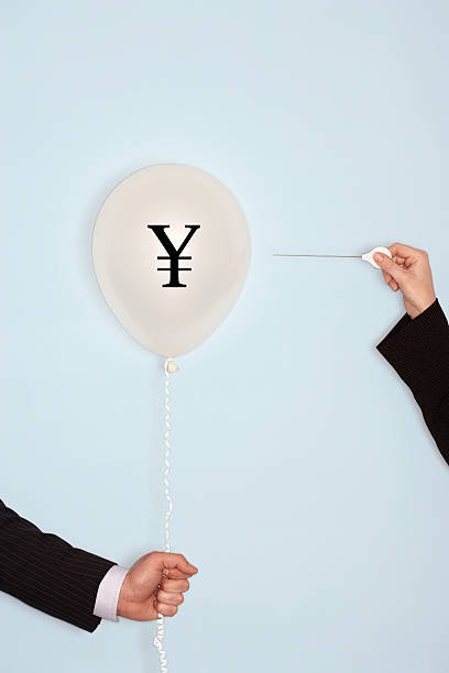 istock Cropped hands holding needle and popping balloon 611334700