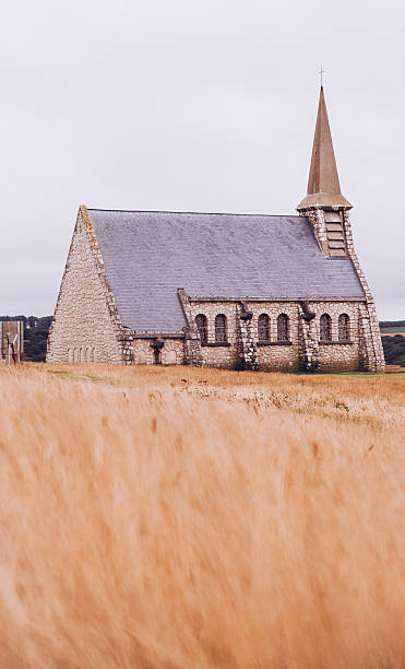 istock Old Church On Field Against Clear Sky 611456649
