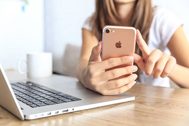 Veliko Tarnovo, Bulgaria - October 1, 2016: Woman holding in the hand an new Apple iPhone 7 Rose Gold  in cafe.  iPhone is a smart cellular phone produced by Apple Computer Inc.