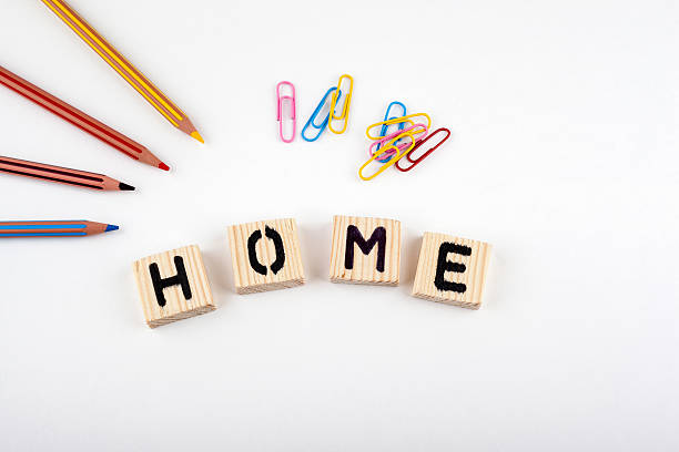 istock Home from wooden letterson on white office desk 611591432