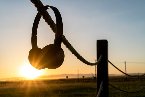 earphone on pasture at sunset