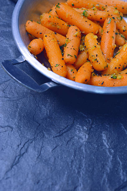 istock Mini carrots stir fry with garlic 611593540