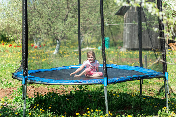 istock Little girl jumping on the trampoline 611593694